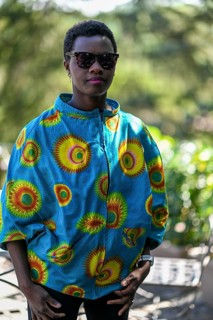 Young adult afro hair diverse black model pose outdoors in african print attire wear sunglasses