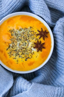 Homemade carrot ginger curcuma spicy soup. Seasonal Pumpkin traditional soup with creamy silky