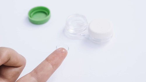 Female showing contact lenses his finger. Resolution and high quality beautiful photo