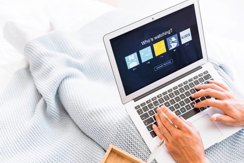 Crop man choosing netflix account