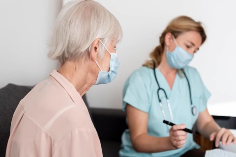 Female nurse elder woman nursing home during check up