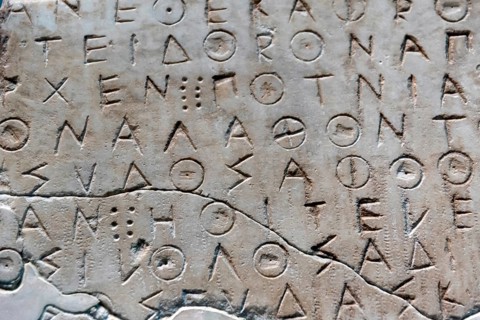 Ancient greek letters in stone abstract background