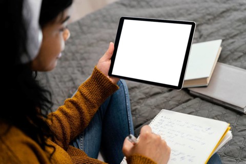 High angle teenage girl using tablet online school