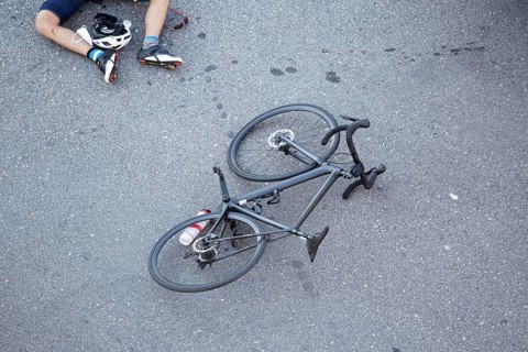 Bicycle accident on the road. Scene of a cyclist and bicycle on the asphalt after being hit by a