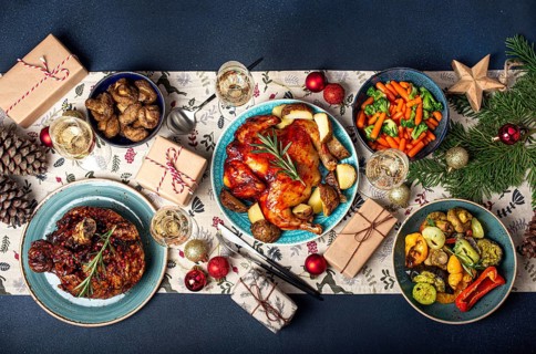 Christmas evening table top view with festive food and sparkling wine glasses, Xmas dinner with
