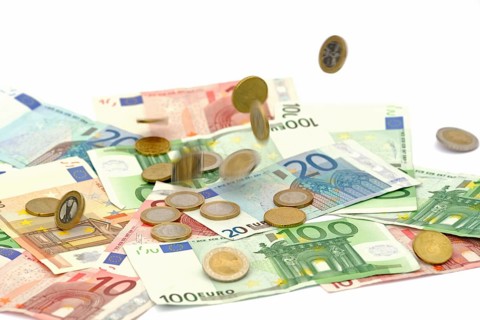 Euro coins fall on euro banknotes, rain of money, high cost, symbolic image