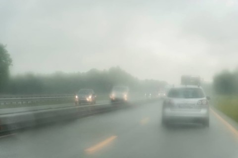 View through the windscreen of a car in rainy weather on the motorway