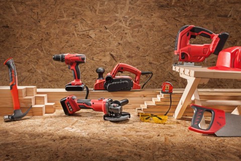 Set of working tools. Electric hand tool set for carpenters. On plywood background