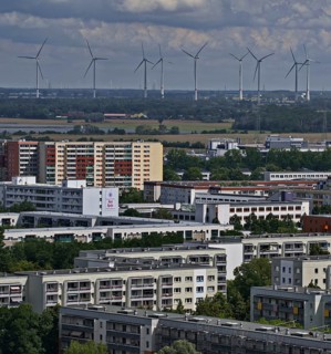 Residential buildings on the outskirts of the city, in the background wind turbines outside the