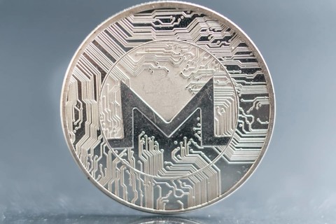 Monero. Crypto currency silver coin, Macro shot of Iota coin isolated on background, cut out