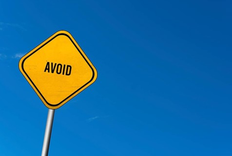Avoid, yellow sign with blue sky