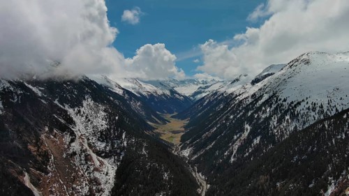 Aerial view of mountains and Krimml Waterfalls on sunny day. High Tauern National Park, Austrian