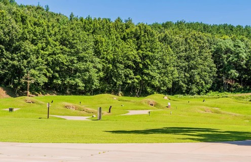 Royal tombs with entrances of stone next to treeline at Neungsa Baekje Temple, South Korea, South