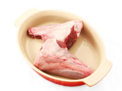 Shanks, raw red meat, chopped, in a dutch oven, unseasoned
