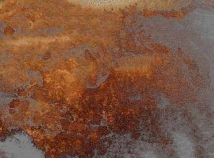 Rusty and weathered surface blending brown, orange, and grey textures, creating a sense of decay