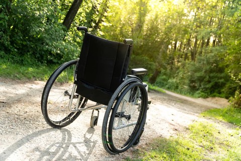 Photo of empty wheelchair parked in park, health care concept