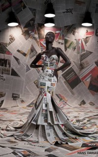 Artistically lit female model wearing an avant-garde dress made of newspapers, AI generated