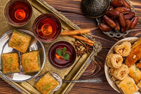 Dry dates saucer near cups tea turkish desserts tray