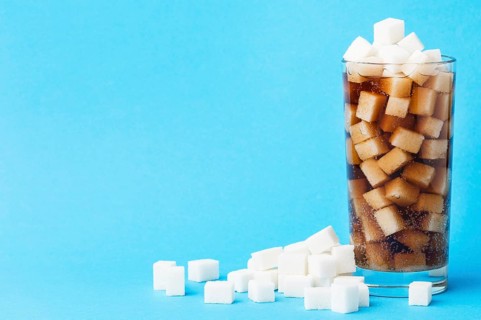 Front view glass soft drink with sugar cubes copy space. High resolution photo