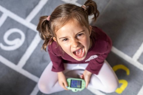Portrait little girl upset because game