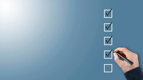 person ticking checkboxes with marker pen on checklist or to-do-list with copy space