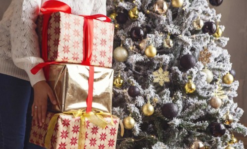 Cropped shot of woman holding stack of Xmas or New Year presents for family members and relatives