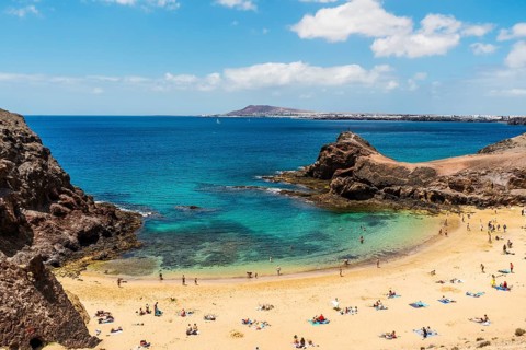 White sand and volcanic rocks at Papagayo Beach located on south end of Lanzarote, Canary Islands,