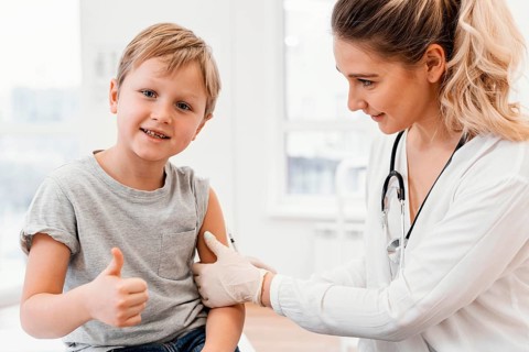 Close up pediatrician vaccinating kid