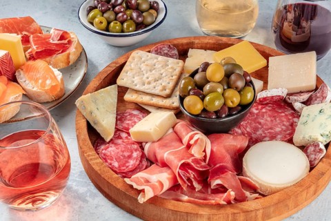 Italian antipasti or Spanish tapas with wine. Charcuterie platter with prosciutto, jamon, cheese,