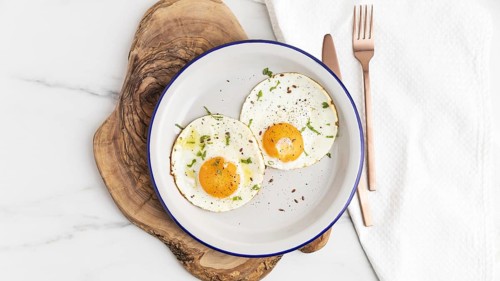Top view breakfast fried eggs plate with cutlery. Resolution and high quality beautiful photo