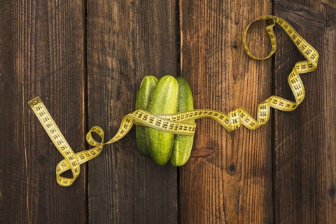 High angle view fresh cucumbers measuring tape wooden background. Resolution and high quality
