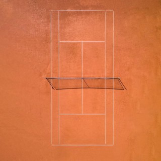 Aerial view of a single red clay tennis court without players