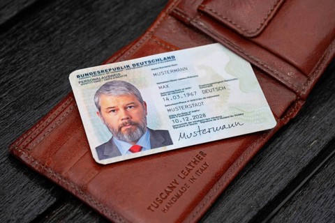 Identity card of the Federal Republic of Germany with a businessman around 50 years old lies on a