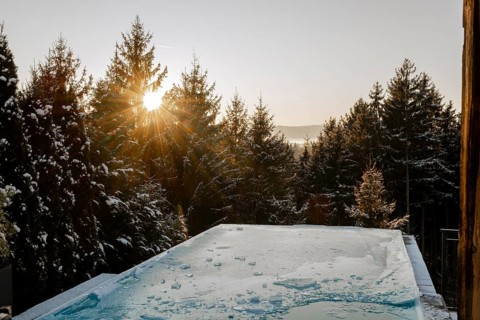 Frozen pool in winter at sunset