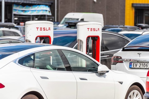 Lyngdal, Norway, August 02 2021: Electric cars charging at a Tesla supercharger, Europe