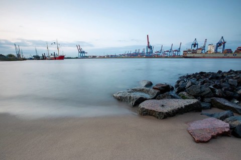 Elbe beach with container terminal and ships in the background in Hamburg