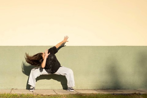 Tennage girl dancing on the street. Copy space