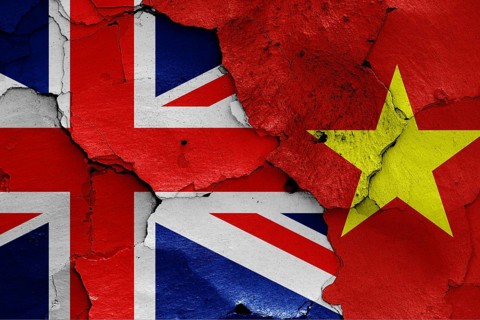 Flags of UK and Vietnam painted on cracked wall