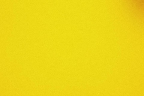 Grainy, textured gradient background with a warm yellow color palette