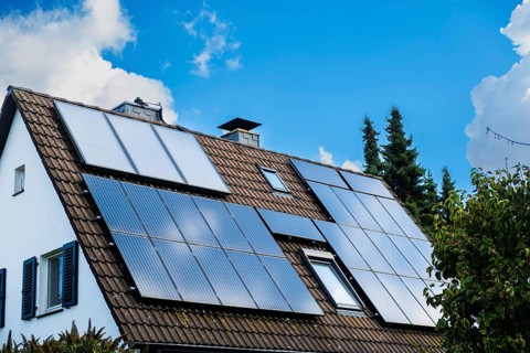 Solar panels and solar thermal energy on the roof of a detached house in Essen, Germany, Europe