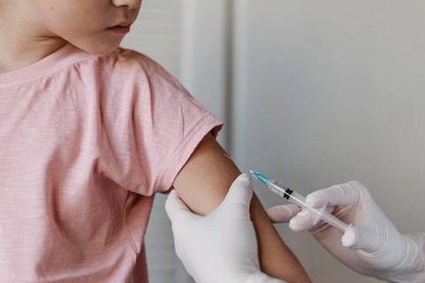 Doctor administering vaccine kid
