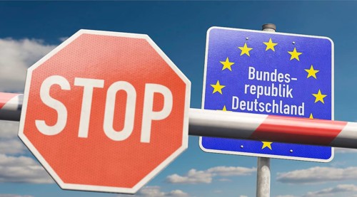 Border control - barrier with stop sign and signpost