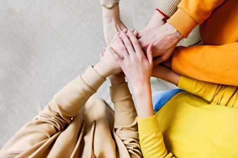 Pile of hands of friends. Teenagers putting their hands together. Close up