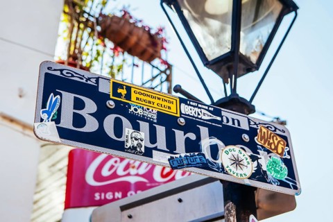 New Orleans, USA, January 24 2013: Bourbon St signage covered in tourism stickers in New Orleans,