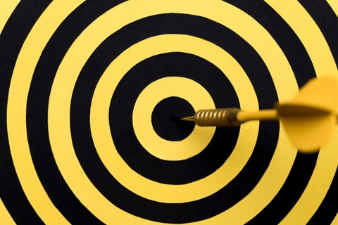 Close up dartboard center with arrow