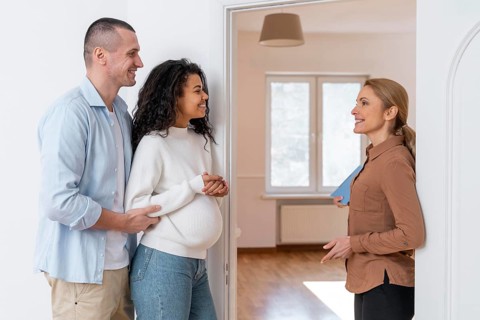 Side view realtor inviting couple see new house