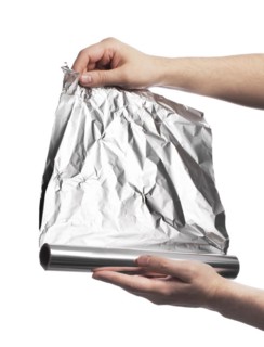 Man holding a roll of household aluminum foil