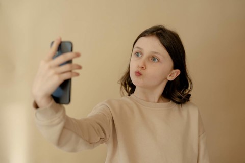 Girl, 10, takes a selfie with mobile phone