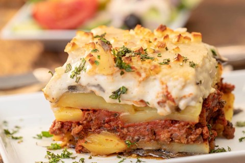 Portion of greek moussaka on wood