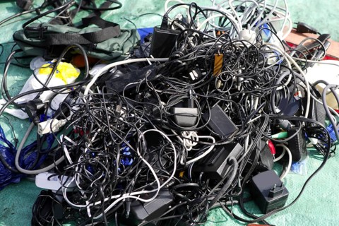 Battery charger and wires mess in second hand market tech trash
